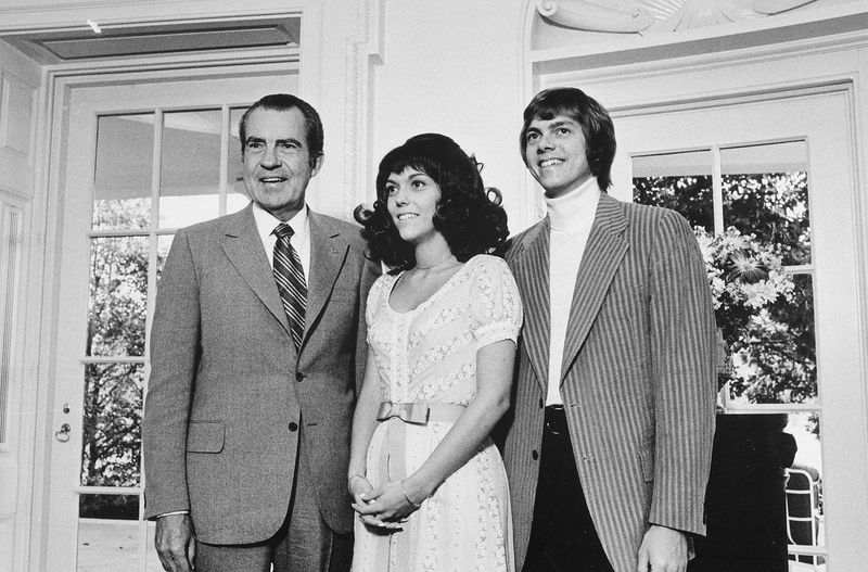 President Richard Nixon standing with Karen and Richard Carpenter in the Oval Office at the White House in August 1972