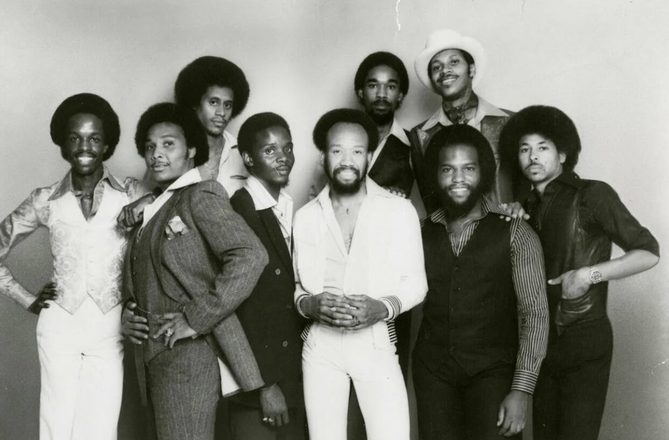 Earth, Wind and Fire in a black and white 1977 Columbia Records press photo, the nine-member lineup a year before September