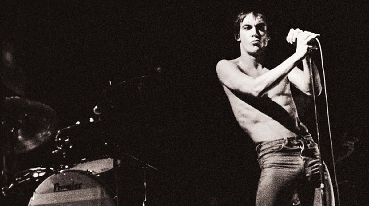 Iggy Pop performing shirtless in 1977 on the Lust for Life tour, drummer Hunt Sales' bass drum visible behind him