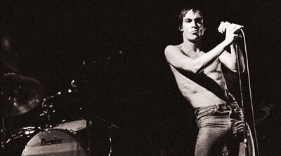 Iggy Pop performing shirtless in 1977 on the Lust for Life tour, drummer Hunt Sales' bass drum visible behind him