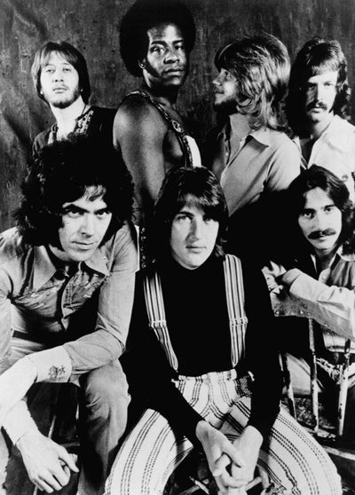 Black and white 1972 portrait of all seven members of Three Dog Night, the band behind Joy to the World